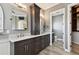 Bathroom featuring dual vanity, dark wood cabinets and granite countertops at 100 Driftwood W Dr, Palm Harbor, FL 34683