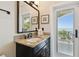 A cozy bathroom featuring a granite countertop vanity and views of the intercoastal waterway at 100 Driftwood W Dr, Palm Harbor, FL 34683