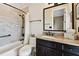 Cozy bathroom featuring a tub with shower, vanity, granite countertop, and bronze fixtures at 100 Driftwood W Dr, Palm Harbor, FL 34683