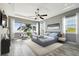 Serene bedroom with water views, a tray ceiling, and abundant natural light from large windows at 100 Driftwood W Dr, Palm Harbor, FL 34683