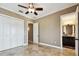 A warm bedroom with tiled flooring, standard closet, and ensuite bath at 100 Driftwood W Dr, Palm Harbor, FL 34683