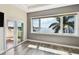 Bedroom with stunning water view, balcony access, and tile floors at 100 Driftwood W Dr, Palm Harbor, FL 34683