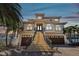 Stunning two-story home featuring a grand staircase, two-car garage, and Mediterranean-style architecture at 100 Driftwood W Dr, Palm Harbor, FL 34683