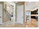Elegant foyer with staircase, soaring ceilings, and view into the kitchen and living room at 100 Driftwood W Dr, Palm Harbor, FL 34683