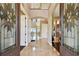 Grand foyer with marble floors, decorative glass door and view to the water at 100 Driftwood W Dr, Palm Harbor, FL 34683
