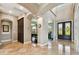 Grand foyer with marble floors, decorative arches, and views of the game room and front door at 100 Driftwood W Dr, Palm Harbor, FL 34683