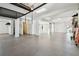Open garage space with epoxy flooring, providing ample room for storage and projects at 100 Driftwood W Dr, Palm Harbor, FL 34683