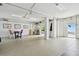 Spacious garage with epoxy flooring, open layout, and access to the outdoor area and water views at 100 Driftwood W Dr, Palm Harbor, FL 34683