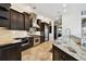 Gourmet kitchen featuring stainless appliances, granite counters, and dark wood cabinetry at 100 Driftwood W Dr, Palm Harbor, FL 34683
