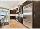 Modern kitchen features stainless appliances, wood cabinets and tile floors at 100 Driftwood W Dr, Palm Harbor, FL 34683