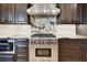 Close-up view of stainless steel Wolf range in modern kitchen with granite counters at 100 Driftwood W Dr, Palm Harbor, FL 34683