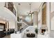 Spacious living room featuring soaring ceilings, a fireplace, a staircase, and an open-concept design at 100 Driftwood W Dr, Palm Harbor, FL 34683