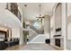 Bright living room featuring soaring ceilings, a fireplace, a staircase, and an open-concept design at 100 Driftwood W Dr, Palm Harbor, FL 34683