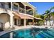 Inviting outdoor patio featuring a covered dining area, poolside seating, and seamless indoor-outdoor transition at 100 Driftwood W Dr, Palm Harbor, FL 34683