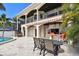 Spacious patio with outdoor dining area and covered living space perfect for entertaining near the pool at 100 Driftwood W Dr, Palm Harbor, FL 34683