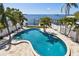 Gorgeous freeform pool featuring tropical landscaping and stunning ocean views, ideal for luxurious outdoor living at 100 Driftwood W Dr, Palm Harbor, FL 34683