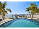 Captivating pool with serene water view and private dock, seamlessly blending luxury and waterfront living at 100 Driftwood W Dr, Palm Harbor, FL 34683