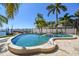 Backyard swimming pool and dock with bay views at 100 Driftwood W Dr, Palm Harbor, FL 34683