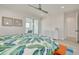 Bright main bedroom with ceiling fan, and sliding glass door leading to an outdoor patio and view of the intercostal at 1110 Bay Pine Blvd, Indian Rocks Beach, FL 33785