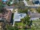 Aerial view of a well-maintained home with lush landscaping and a serene neighborhood setting at 1220 Parkview Ln, Largo, FL 33770