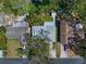 Birds-eye view of a residential property featuring mature landscaping, a tidy yard, and a paved driveway at 1220 Parkview Ln, Largo, FL 33770