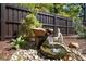 Garden waterfall feature with a stone base, surrounding river rock and a Buddha statue at 1220 Parkview Ln, Largo, FL 33770