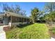 A lush backyard featuring verdant grass, tropical plants and landscaping at 1220 Parkview Ln, Largo, FL 33770