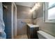 Bathroom featuring modern vanity, tiled walls, and a shower with updated fixtures at 1220 Parkview Ln, Largo, FL 33770