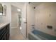 Bathroom boasts blue bathtub and shower with view of an adjacent bedroom at 1220 Parkview Ln, Largo, FL 33770