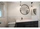 Bathroom features new vanity with modern fixtures and a decorative round mirror at 1220 Parkview Ln, Largo, FL 33770