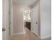 Hallway view into updated bathroom with modern vanity, fixtures, and lighting at 1220 Parkview Ln, Largo, FL 33770