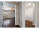 Bedroom view showcasing hardwood floors, fan, and an adjacent walk-in closet with sliding doors at 1220 Parkview Ln, Largo, FL 33770