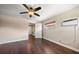 Bedroom featuring hardwood floors, modern ceiling fan, and efficient split unit at 1220 Parkview Ln, Largo, FL 33770