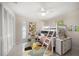 Bright ' bedroom with a bunk bed, ceiling fan, colorful rug, and closet for ample storage at 1220 Parkview Ln, Largo, FL 33770