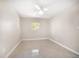 This bedroom features neutral walls, window and a ceiling fan at 1220 Parkview Ln, Largo, FL 33770