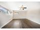 Bright bedroom with hardwood floors, ceiling fan, and sunlit windows providing natural light at 1220 Parkview Ln, Largo, FL 33770