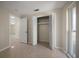 Bedroom features open closet and neutral walls, providing lots of storage at 1220 Parkview Ln, Largo, FL 33770