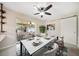 Bright dining room featuring a modern ceiling fan, a six-chair table, and sliding glass doors to an enclosed patio at 1220 Parkview Ln, Largo, FL 33770