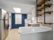 Updated kitchen with stainless steel appliances, white cabinets, and open shelving at 1220 Parkview Ln, Largo, FL 33770