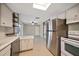 Bright kitchen featuring stainless steel refrigerator and an open design flowing into the adjoining room at 1220 Parkview Ln, Largo, FL 33770