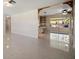 Bright living room with tile flooring, an open floor plan, and views of the covered patio through sliding glass doors at 1220 Parkview Ln, Largo, FL 33770