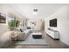 Bright living room with large windows, comfortable seating, and stylish decor at 1220 Parkview Ln, Largo, FL 33770