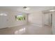 Open-concept living room with bright natural light, tiled floors, and direct access to other rooms in the house at 1220 Parkview Ln, Largo, FL 33770