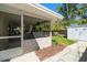 Outdoor patio with tiled floors, a ceiling fan, and a view of the shed and fenced yard at 1220 Parkview Ln, Largo, FL 33770