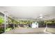 Covered patio featuring an outdoor ceiling fan and a view of the fenced backyard with lush, tropical landscaping at 1220 Parkview Ln, Largo, FL 33770