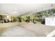 A spacious covered patio offering views of the backyard's landscaped areas and a white storage shed at 1220 Parkview Ln, Largo, FL 33770