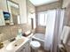 Updated bathroom featuring tiled walls, a shower-tub, and a modern vanity with sink at 12400 Park Blvd # 408, Seminole, FL 33772
