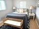 Comfortable bedroom featuring neutral decor, a cozy area rug, and a stylish wicker bench at 12400 Park Blvd # 408, Seminole, FL 33772