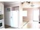 Open layout showing kitchen view and entryway to living room with ceiling fan at 12400 Park Blvd # 408, Seminole, FL 33772
