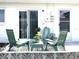 Covered patio with outdoor seating and tropical landscaping creates a serene retreat at 12400 Park Blvd # 408, Seminole, FL 33772